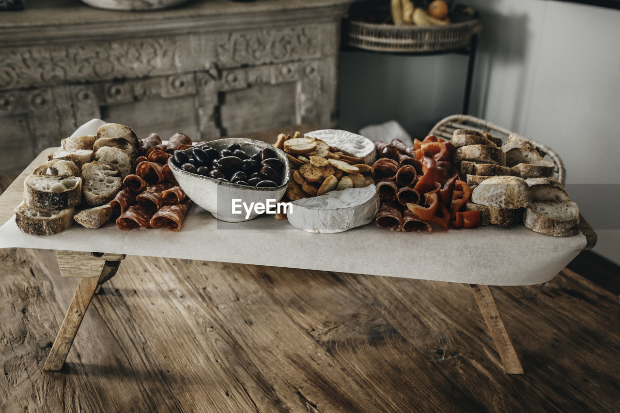 Party platter, grazing board with assortment of finger food on wooden table