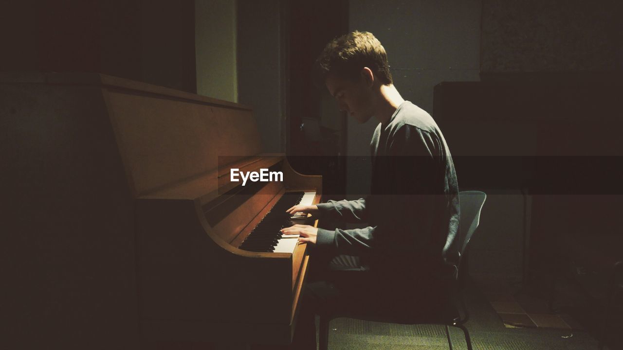 Man playing piano at home