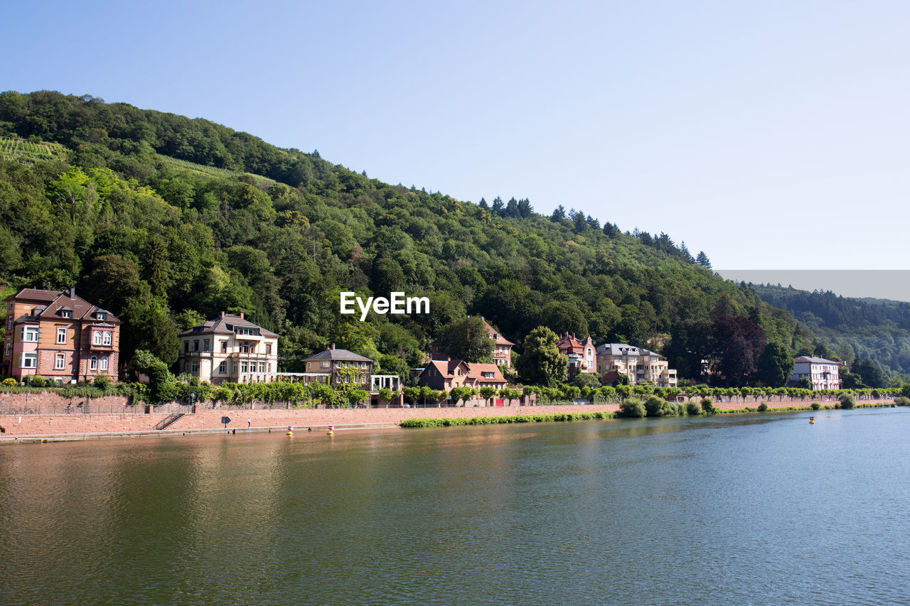 SCENIC VIEW OF LAKE BY BUILDINGS AGAINST SKY