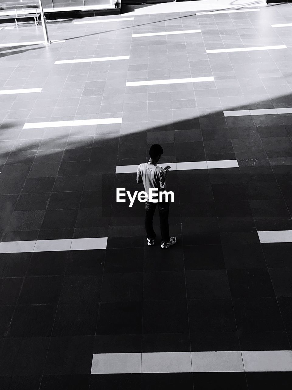 High angle view of man standing on footpath