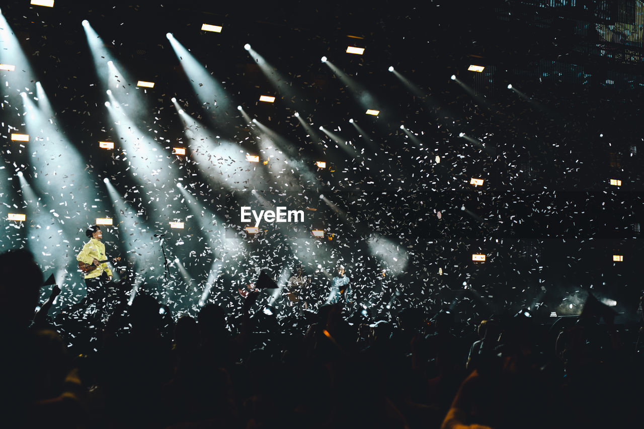 GROUP OF PEOPLE IN THE DARK AT NIGHT