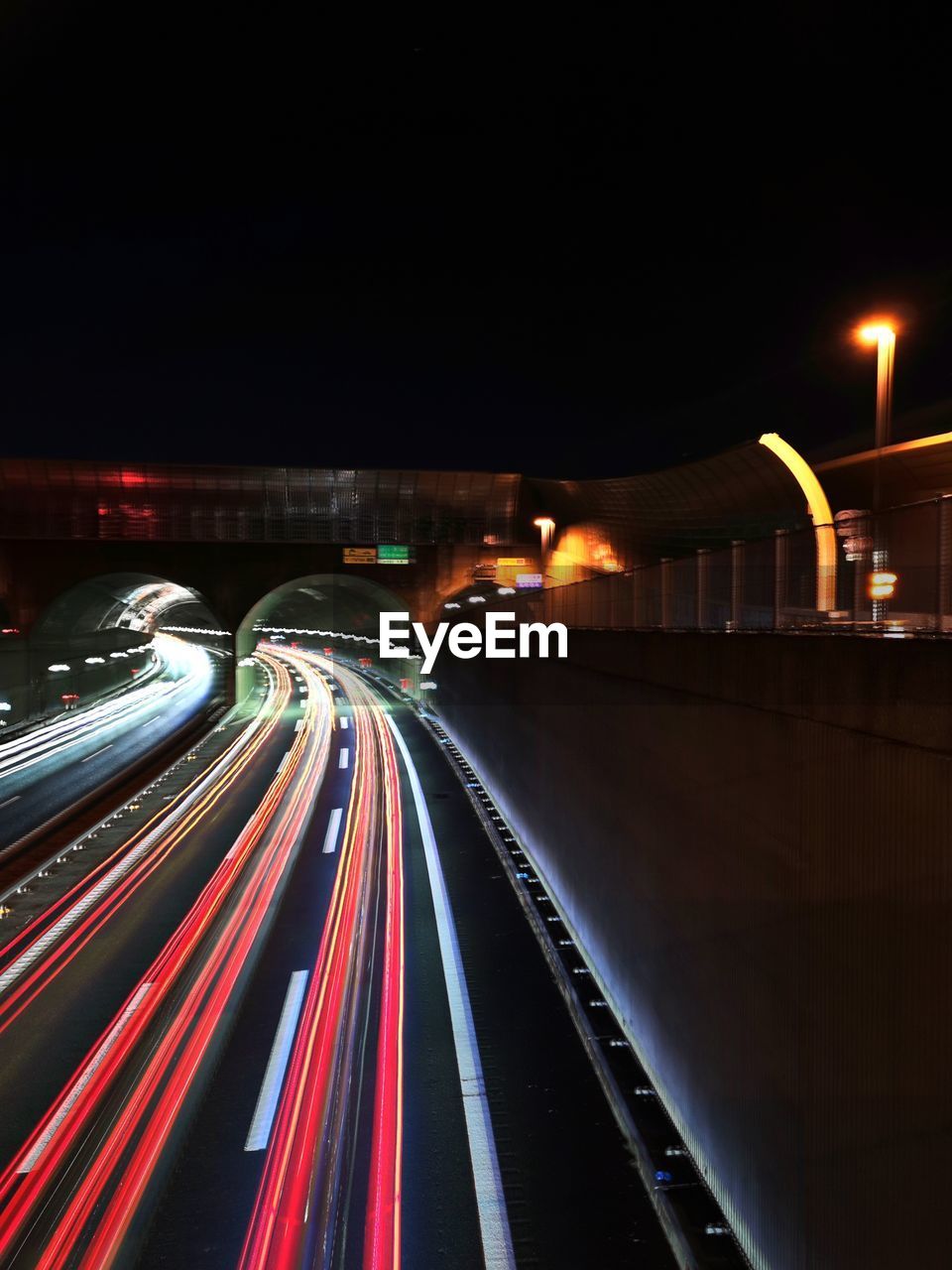 light trail, illuminated, night, long exposure, transportation, motion, speed, architecture, light, city, road, traffic, street, tail light, darkness, blurred motion, mode of transportation, built structure, street light, no people, city life, highway, building exterior, lighting equipment, motor vehicle, headlight, evening, car, lighting, light - natural phenomenon, city street, infrastructure, outdoors, travel destinations, nature, red, on the move, sky, travel, multi colored, bridge