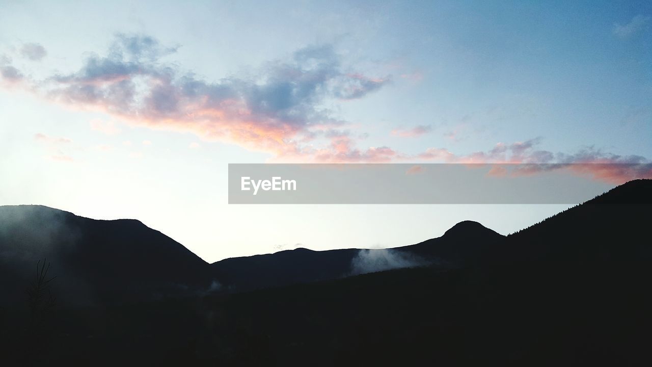 SILHOUETTE MOUNTAINS AGAINST SKY AT SUNSET