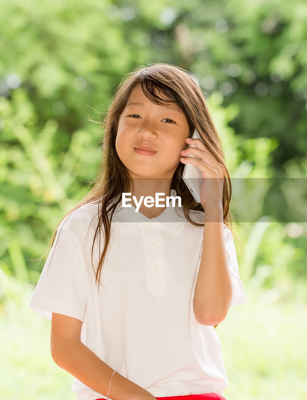 Portrait of smiling young woman standing outdoors
