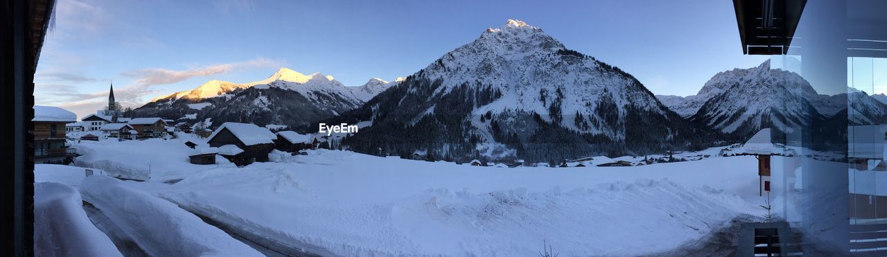 SCENIC VIEW OF SNOWCAPPED MOUNTAINS AGAINST SKY DURING WINTER
