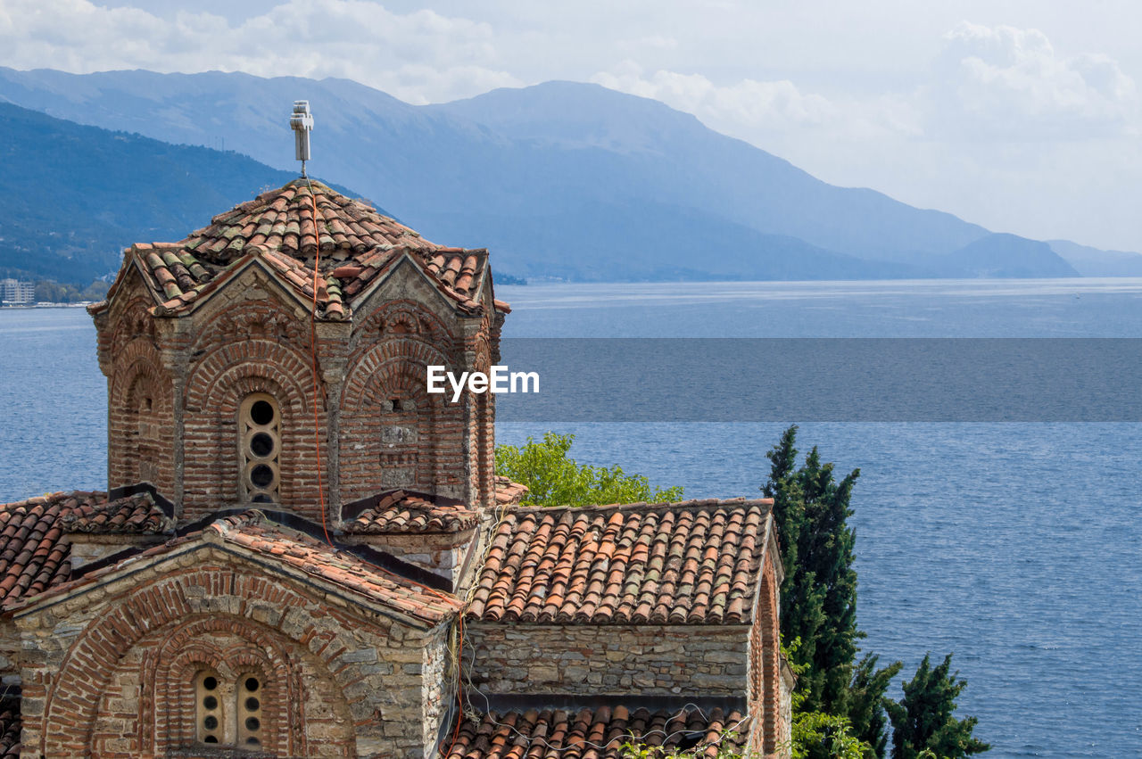 SCENIC VIEW OF SEA WITH MOUNTAINS IN BACKGROUND