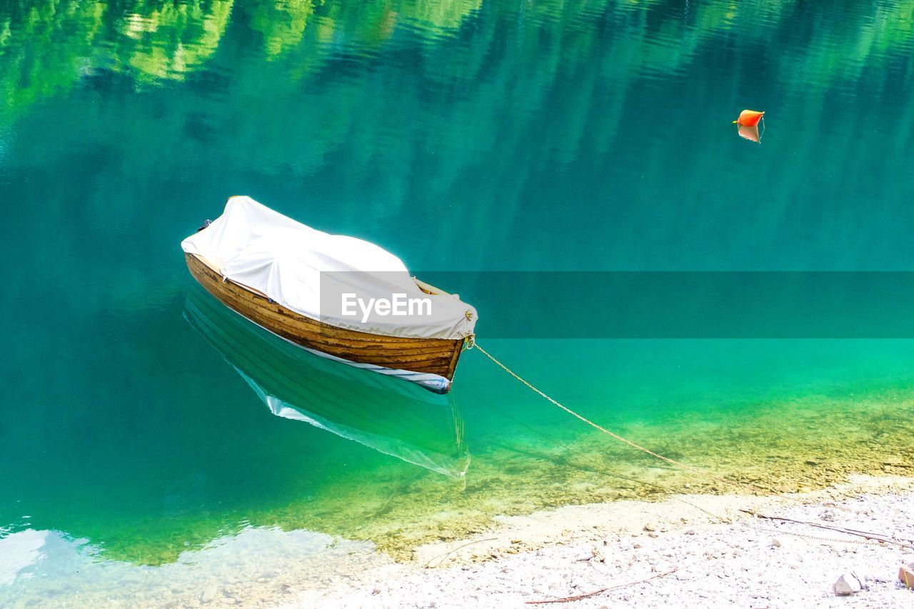 High angle view of boat moored in lake water, molveno, dolomites