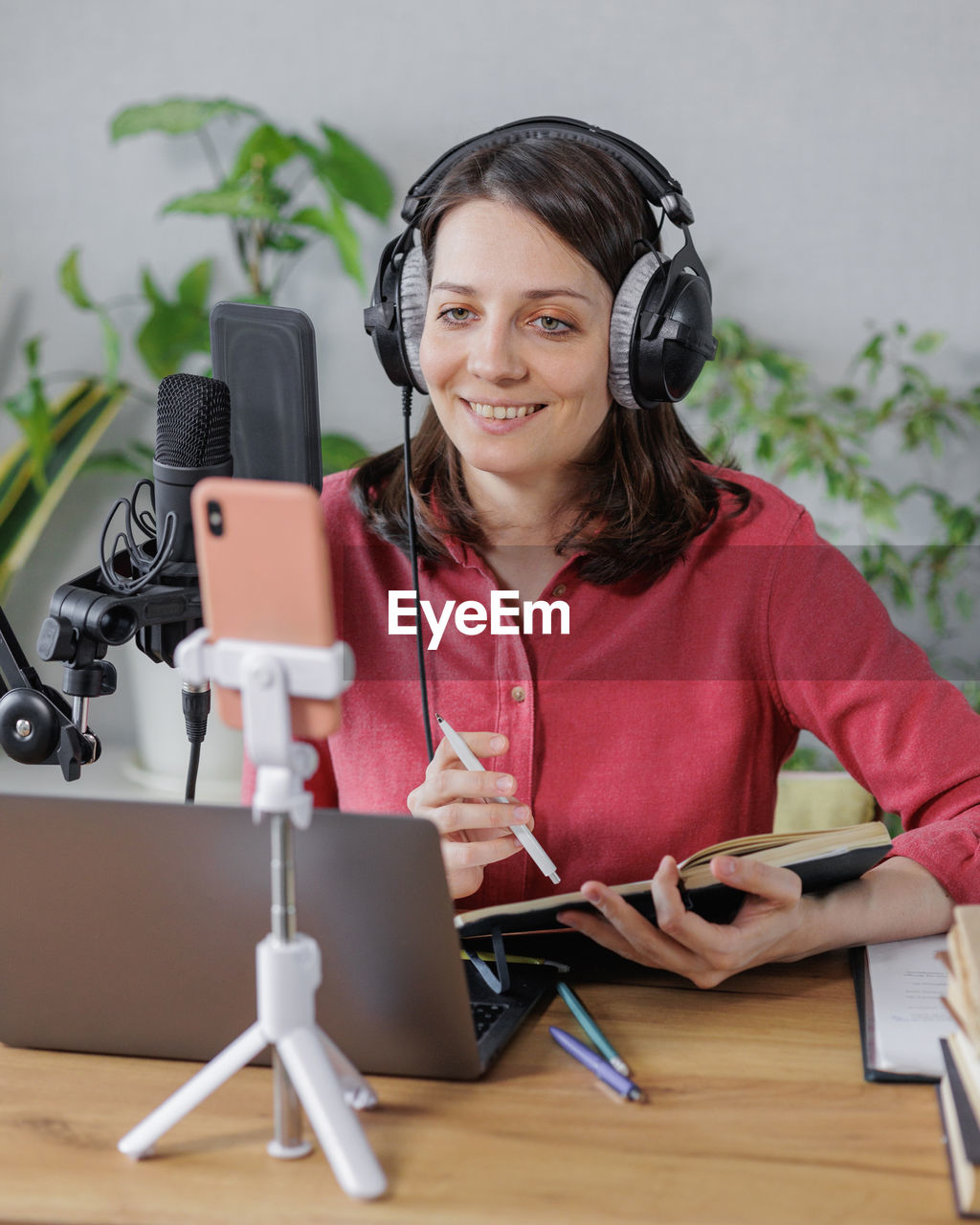 portrait of smiling young woman using phone