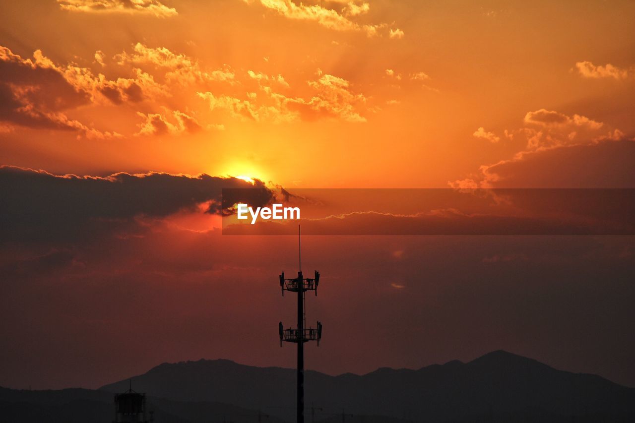 Low angle view of silhouette pole against sky during sunset