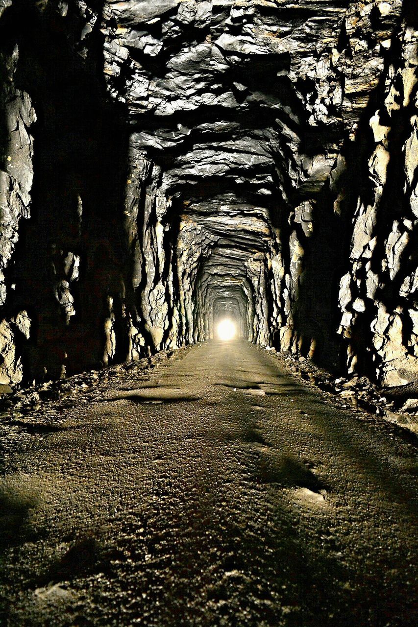 Dirt road in rocky tunnel