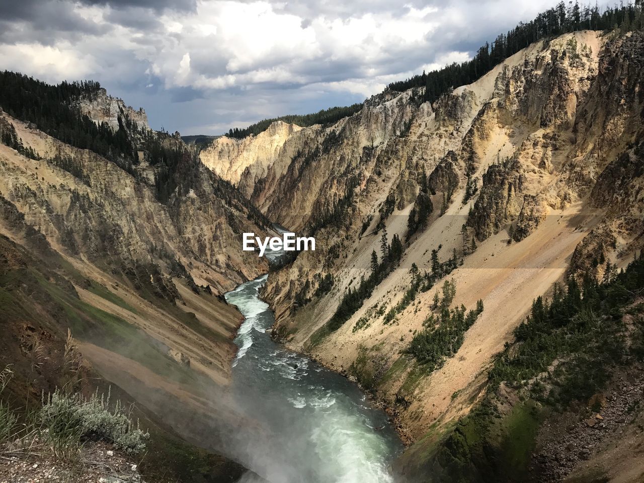 Scenic view of waterfall against sky