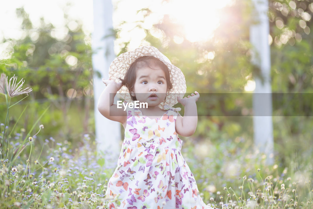 Full length of cute baby girl on field