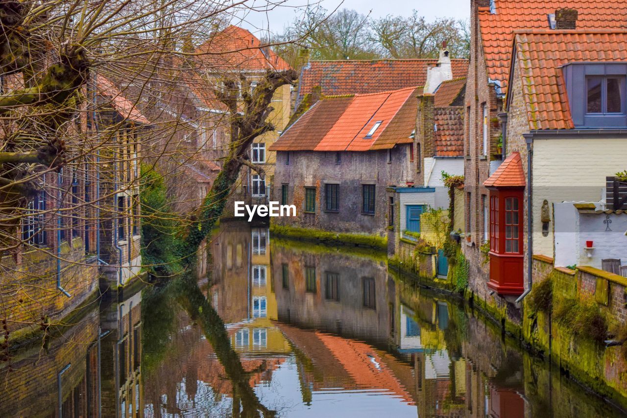 Canal amidst houses and buildings in city