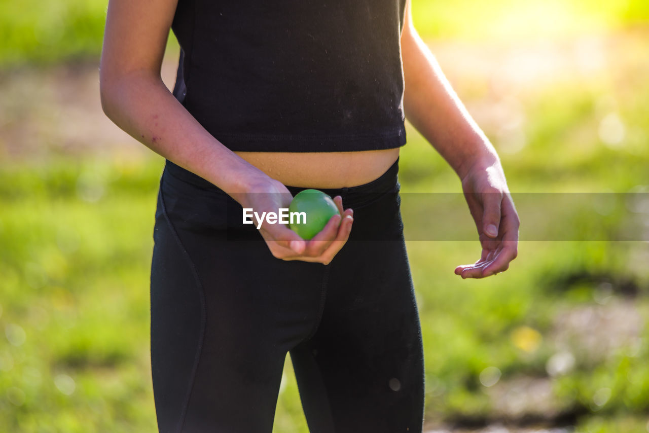 Midsection of woman holding water bomb