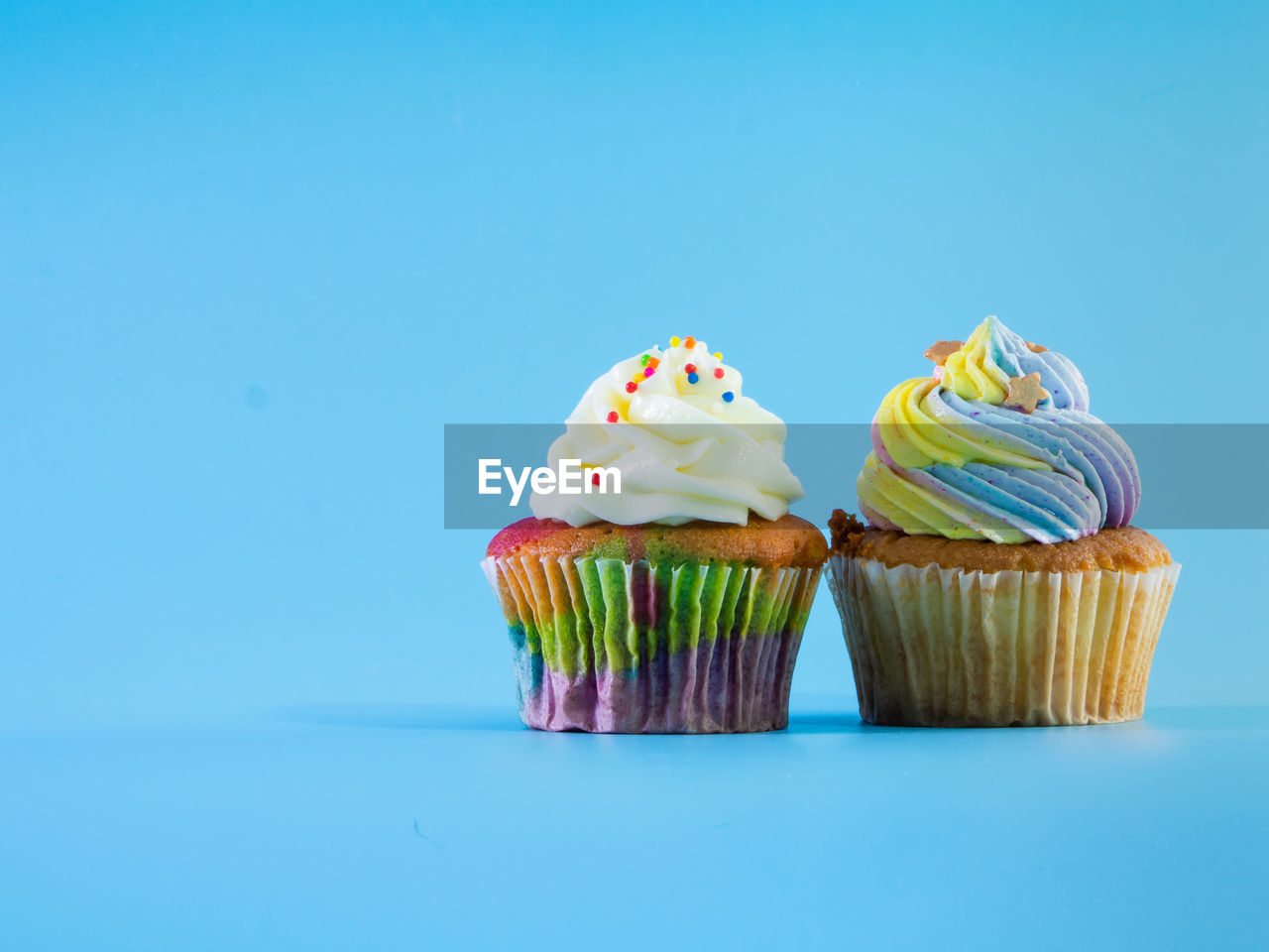 CLOSE-UP OF CUPCAKE AGAINST BLUE BACKGROUND