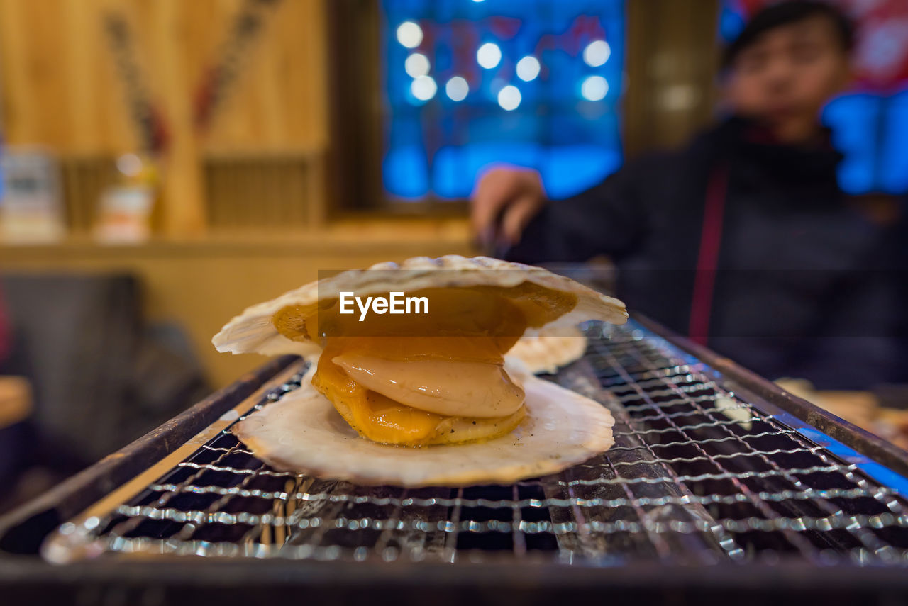 Man preparing seafood on barbecue grill