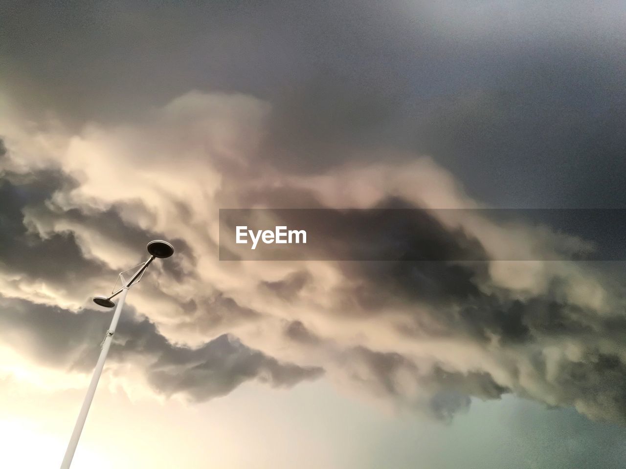 LOW ANGLE VIEW OF STREET LIGHT AGAINST SKY DURING SUNSET