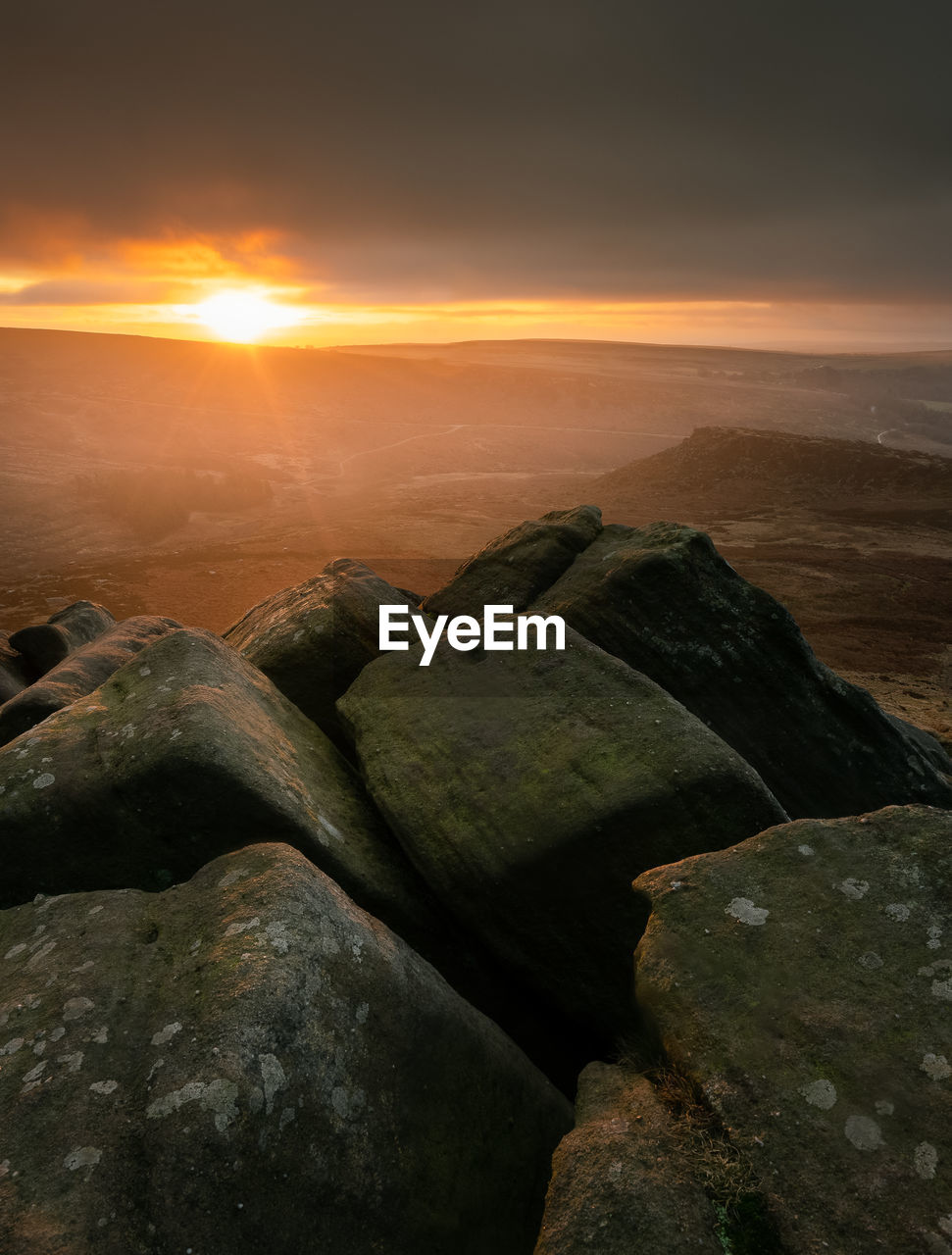 SCENIC VIEW OF ROCKS AGAINST SKY AT SUNSET