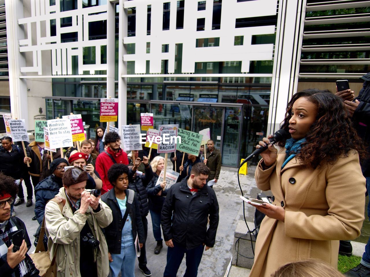 GROUP OF PEOPLE STANDING AGAINST BUILDINGS