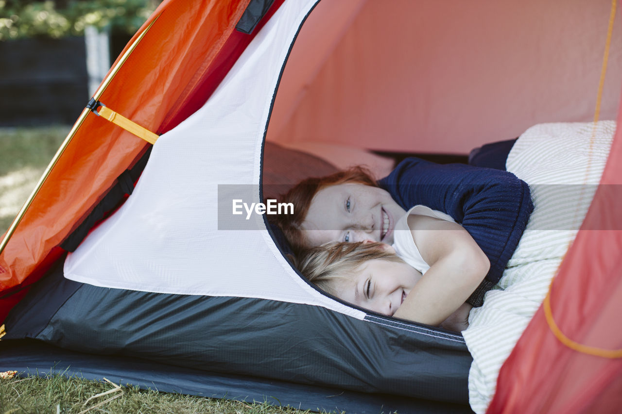 Brother and sister in tent