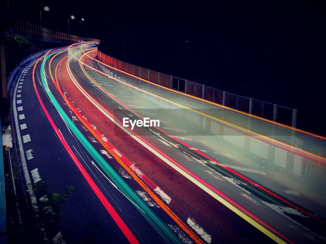 High angle view of light trails on highway at night