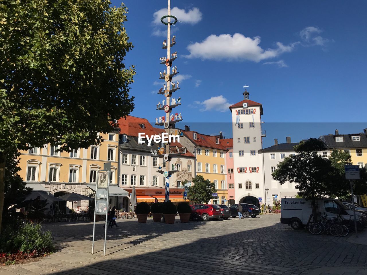 Road by buildings in city against sky