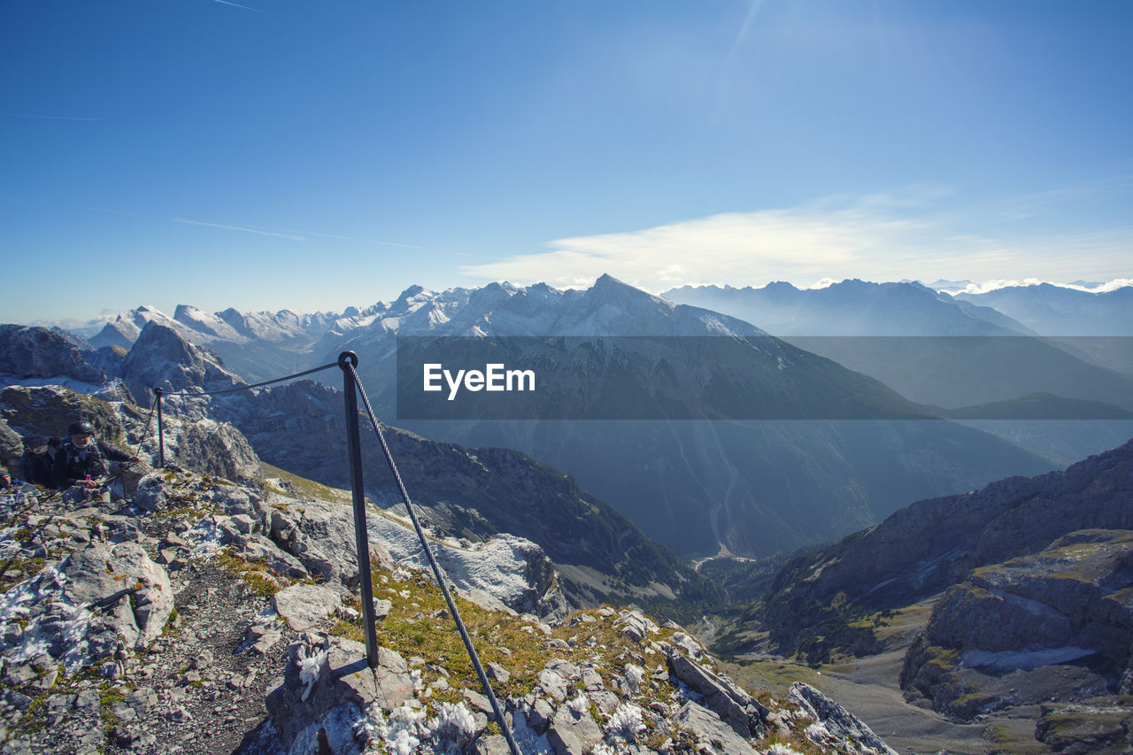 Scenic view of snowcapped mountains against blue sky