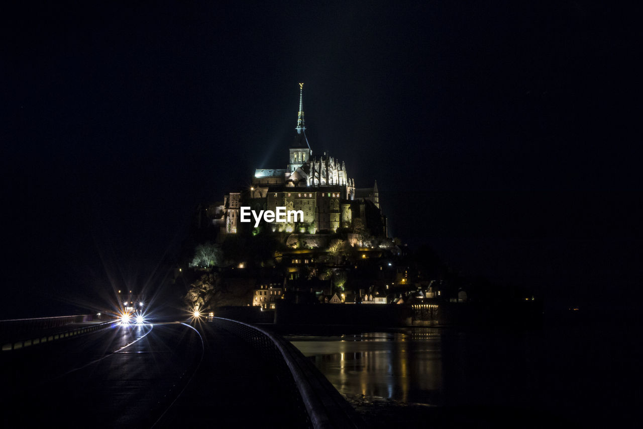 VIEW OF ILLUMINATED CITY AT NIGHT