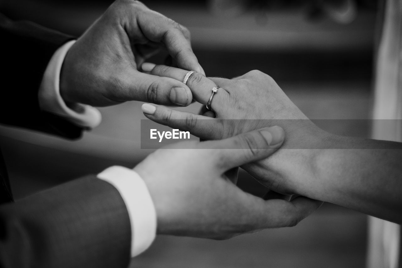 Midsection of couple during wedding ceremony