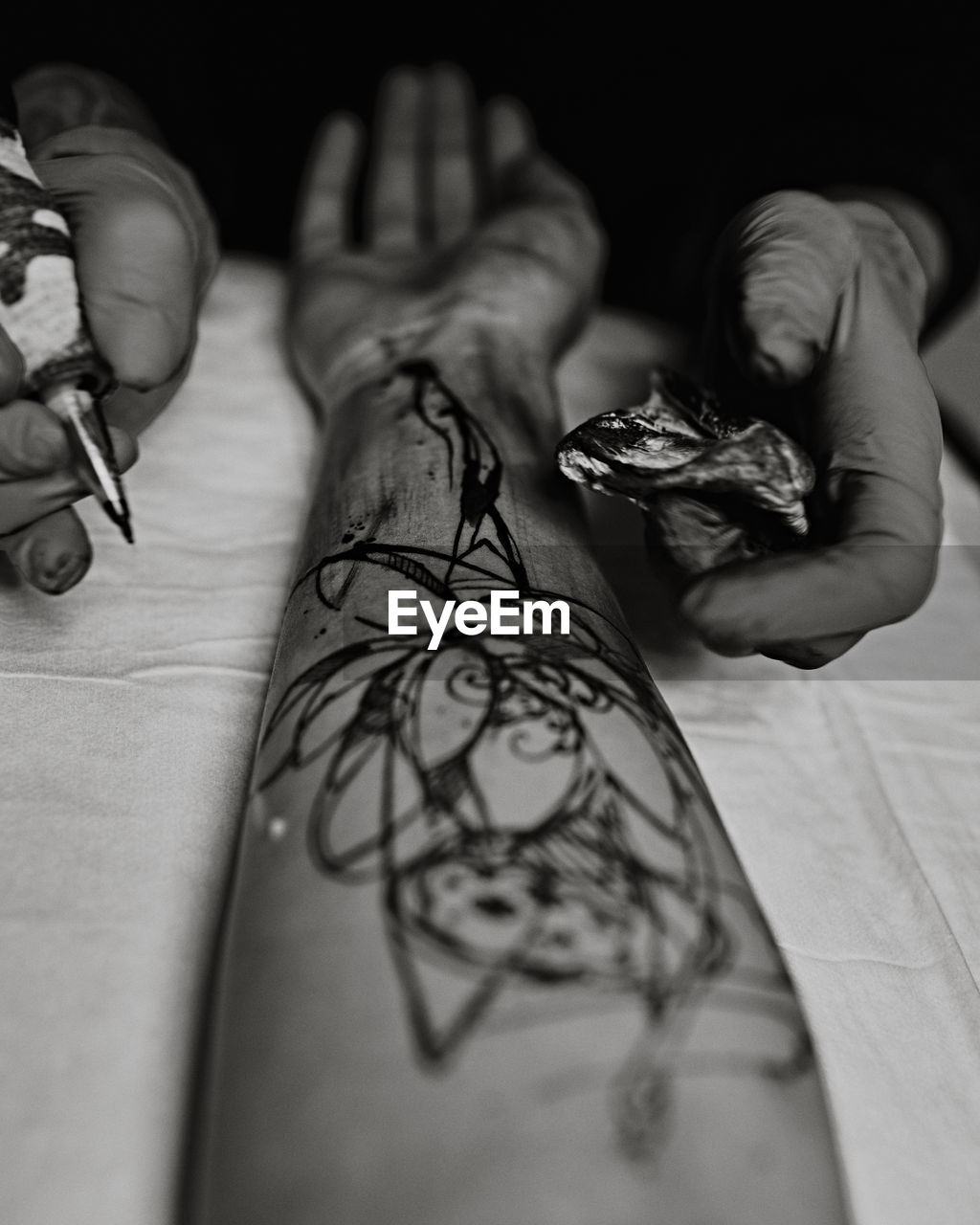 Close-up of human hand holding tattoo machine