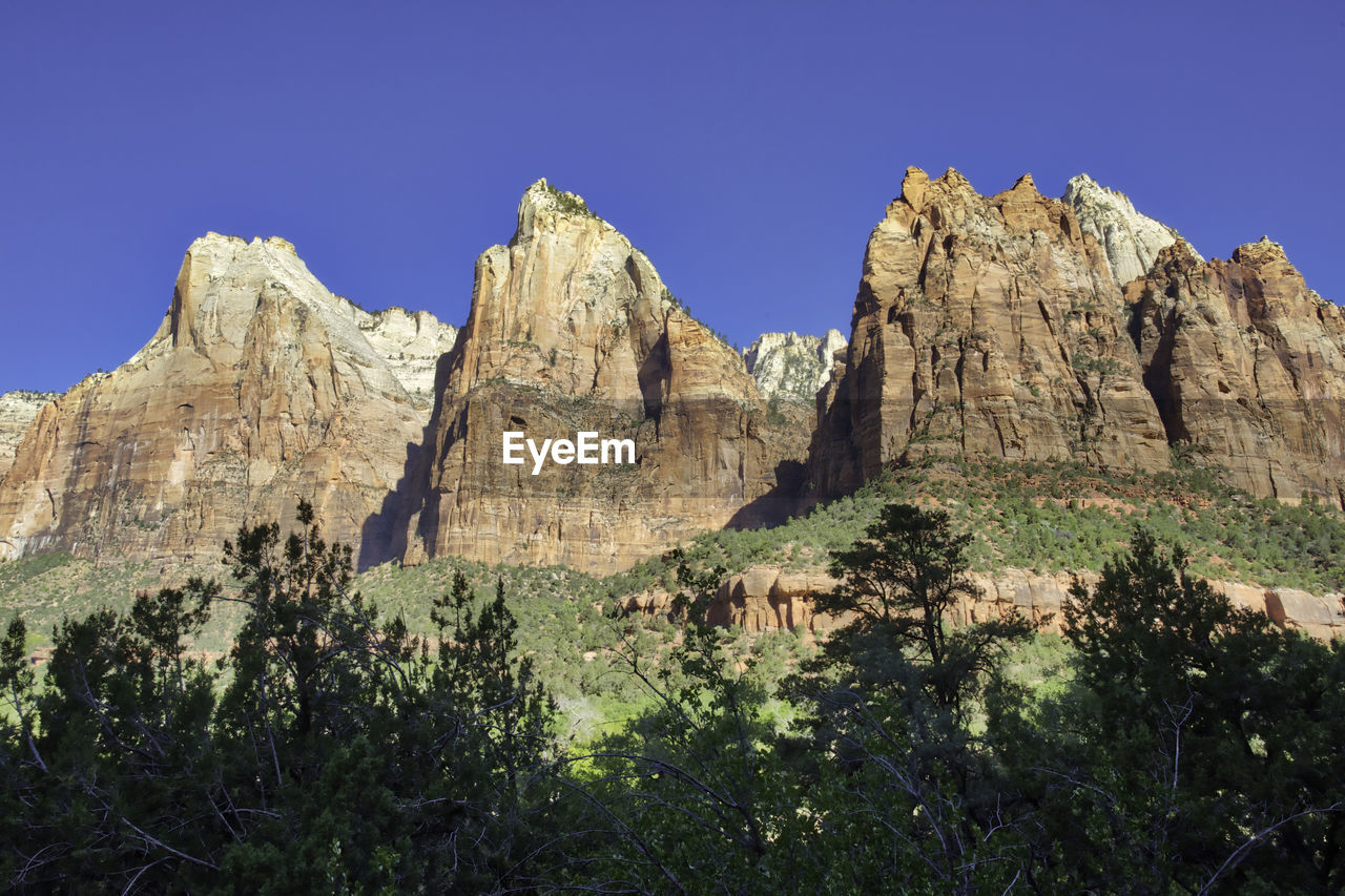 Scenic view of rocky mountains against clear blue sky