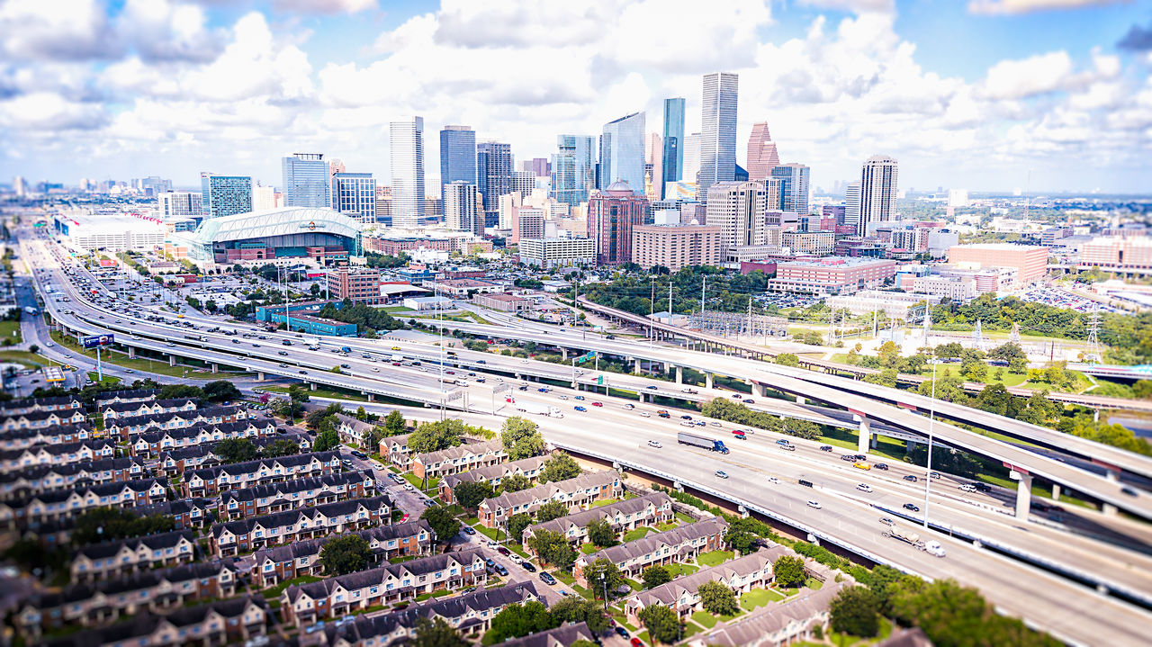 View of cityscape against cloudy sky