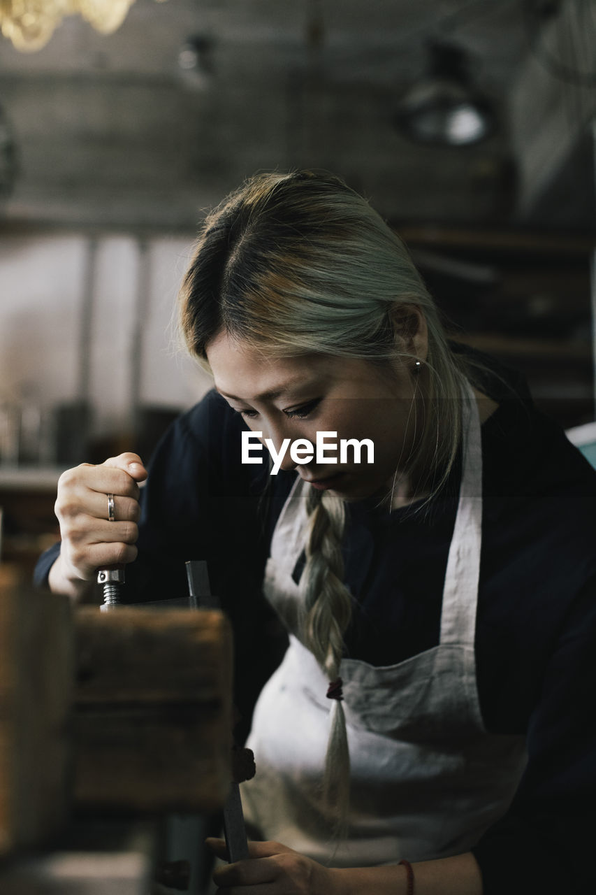 Female entrepreneur working at upcycling workshop