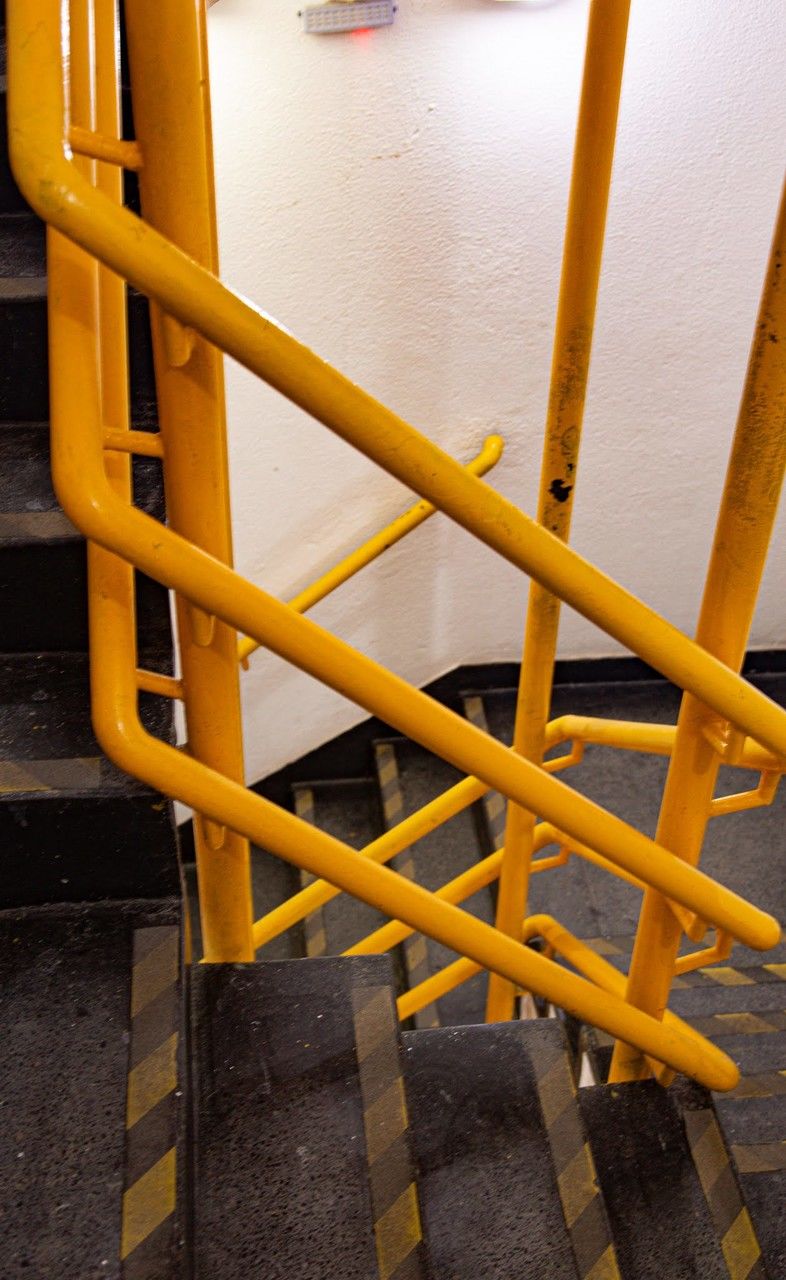 yellow, architecture, no people, handrail, furniture, stairs, wood, railing, high angle view, staircase, built structure, metal, outdoors, day, floor, chair, seat, water