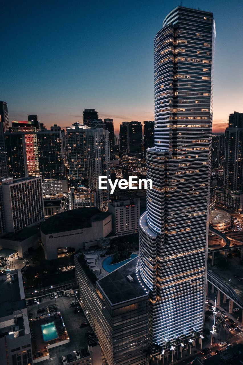 Aerial view of illuminated cityscape against clear sky