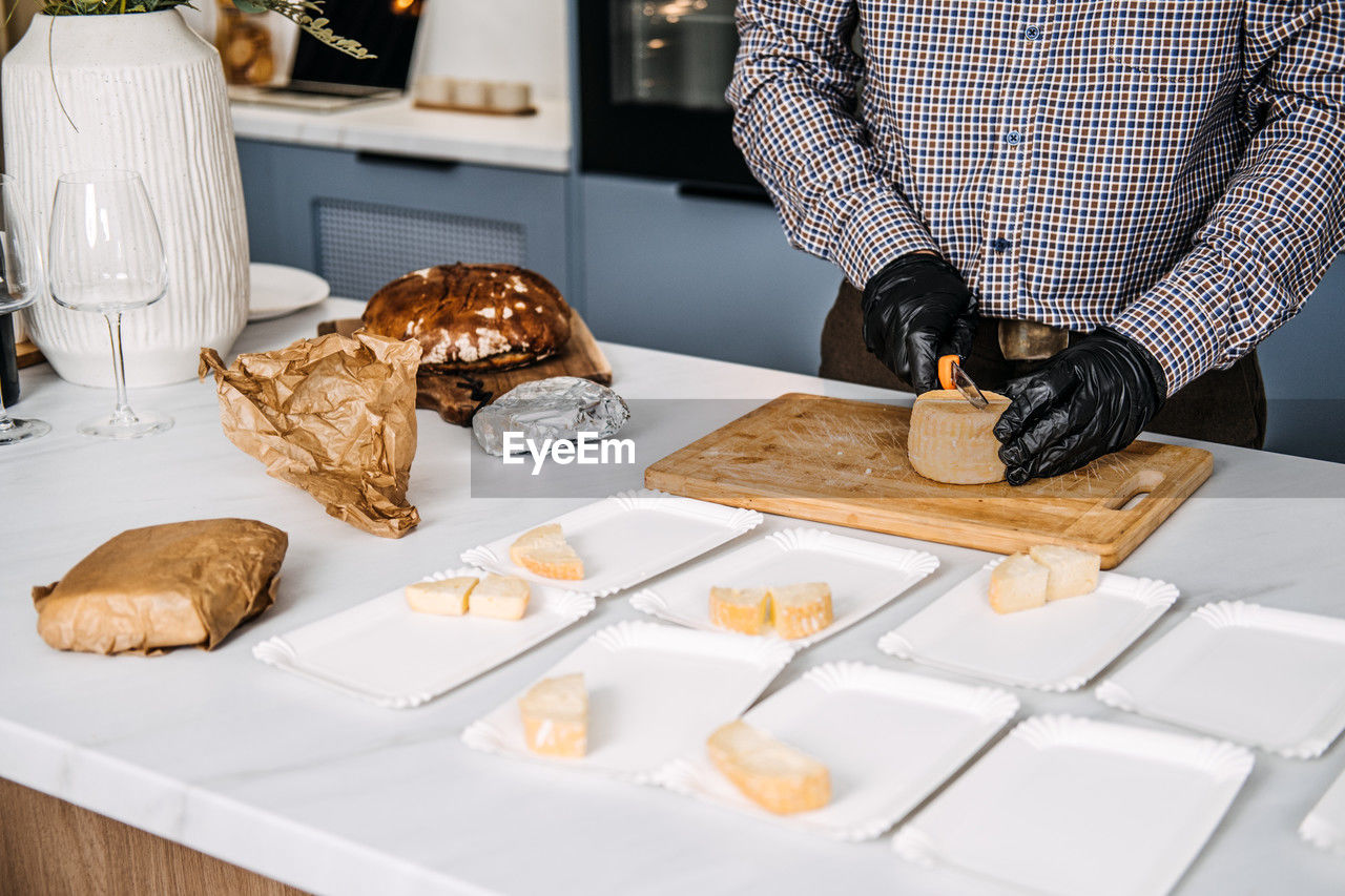 Midsection of man preparing food on table