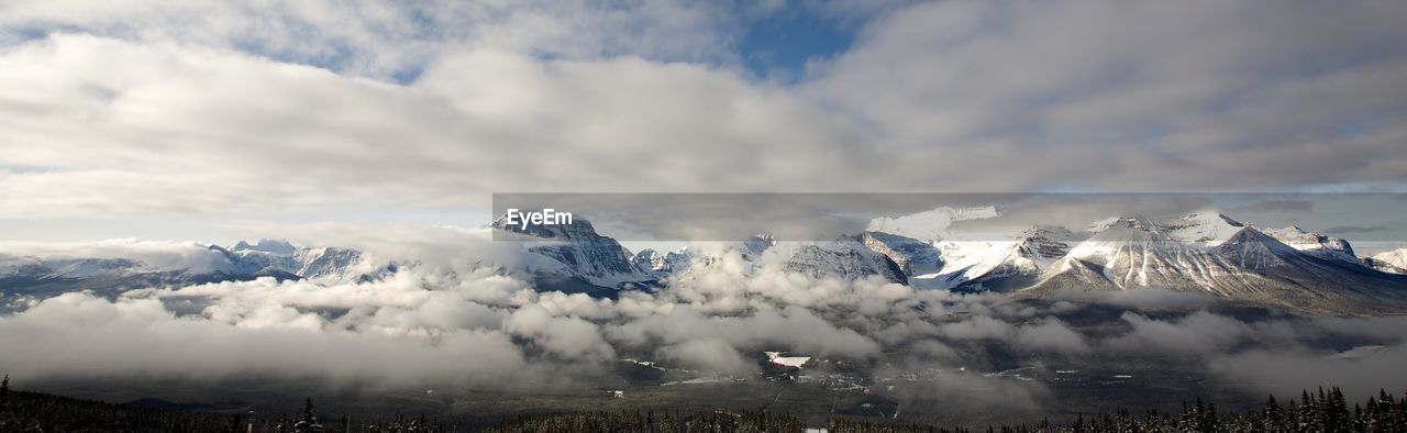 Panoramic view of mountains at banff national park against cloudy sky during winter