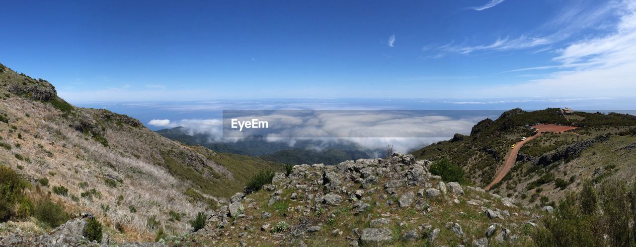 Panoramic view of landscape against blue sky