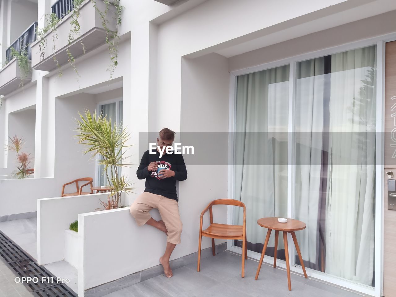 FULL LENGTH OF MAN SITTING ON TABLE