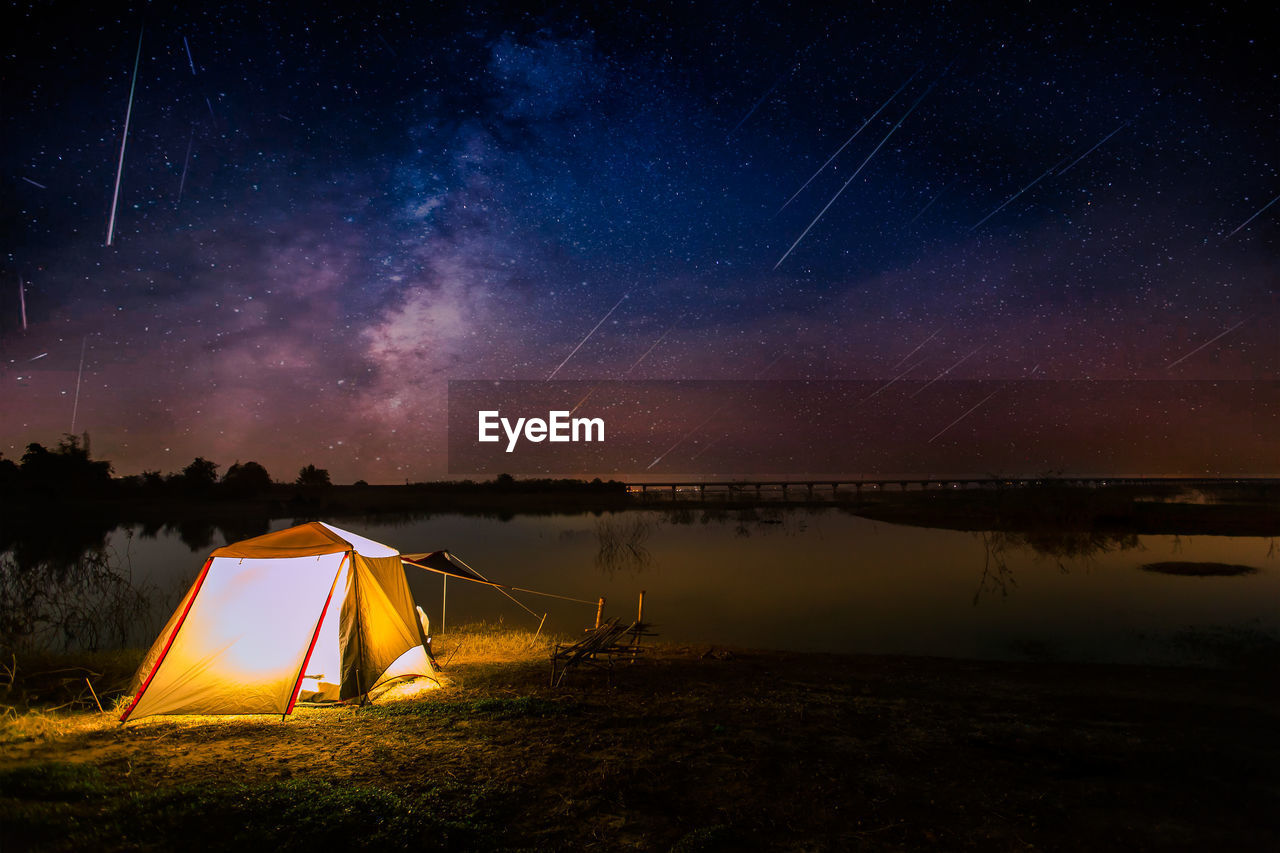 SCENIC VIEW OF ILLUMINATED TENT AGAINST SKY