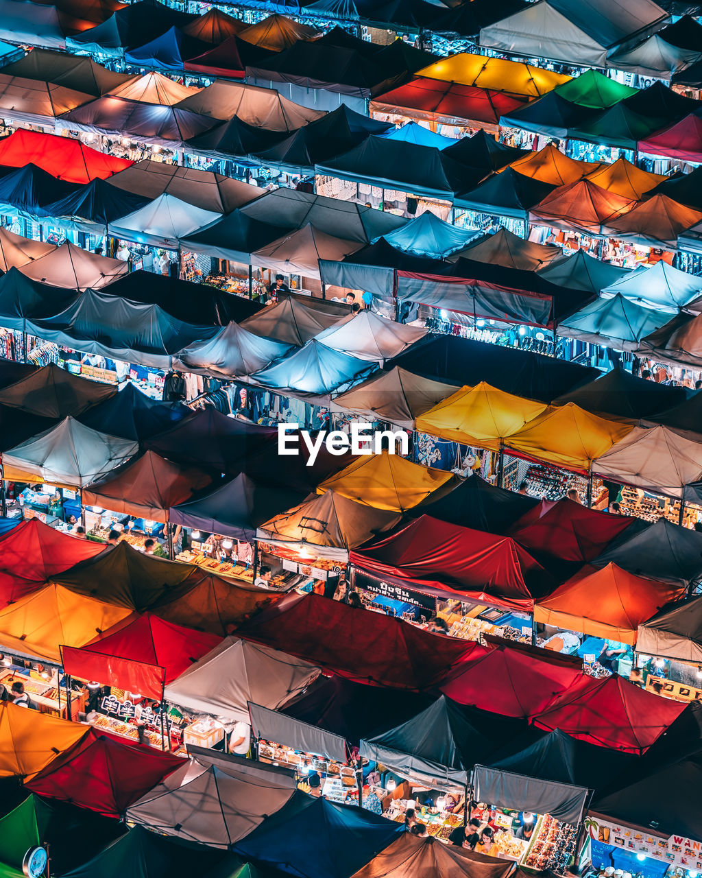 High angle view of multi colored tents at market stall in city during night