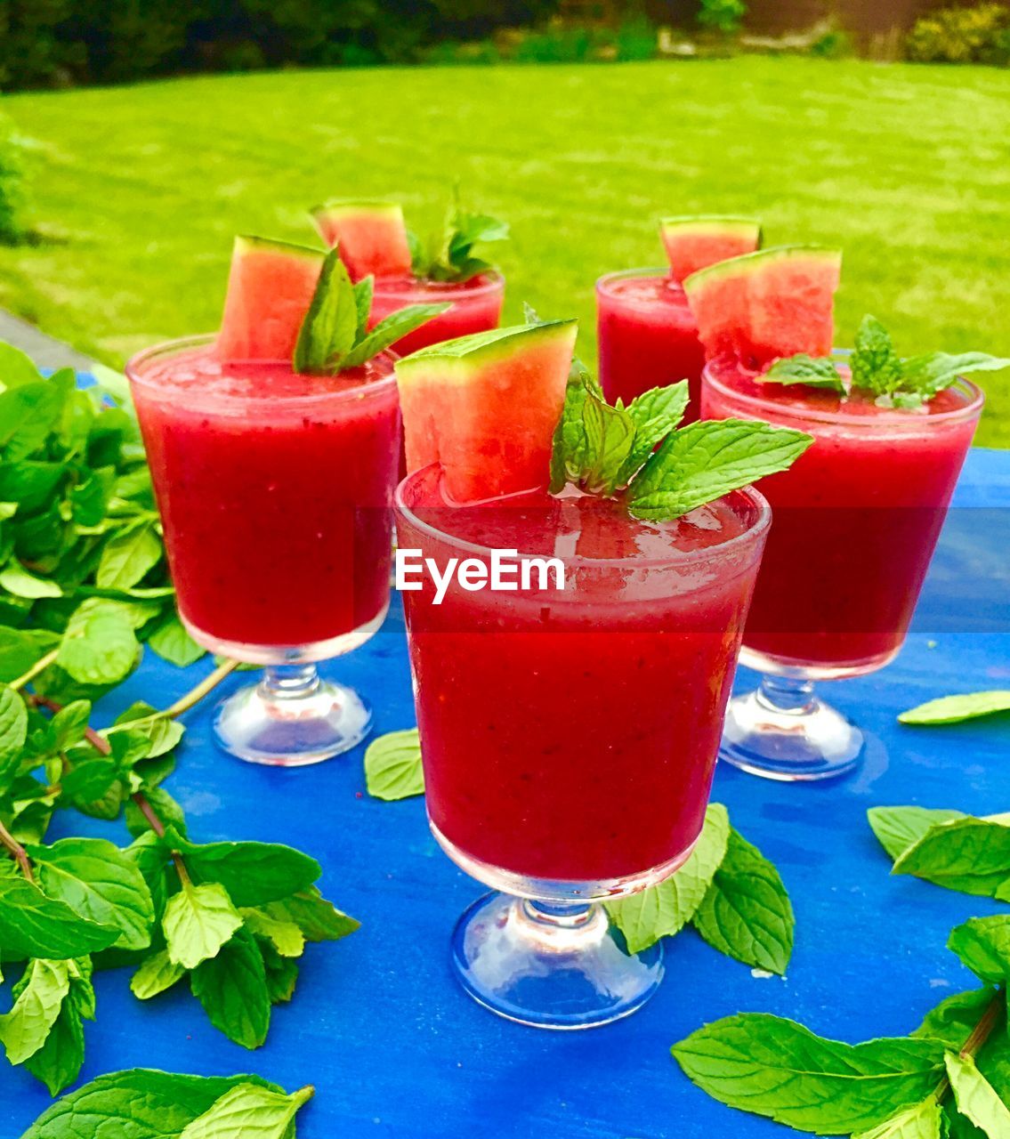 High angle view of watermelon juice with basil served on table