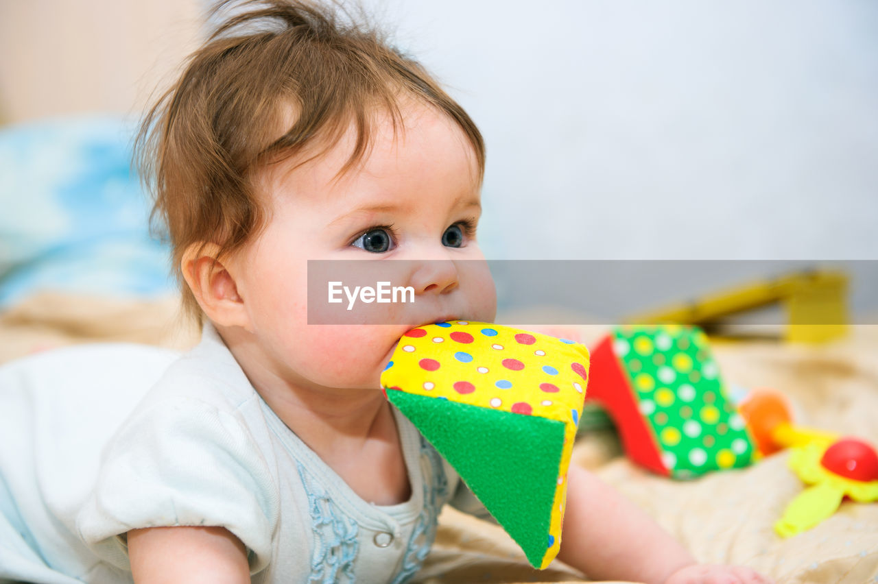 Close-up of cute baby girl holding gift