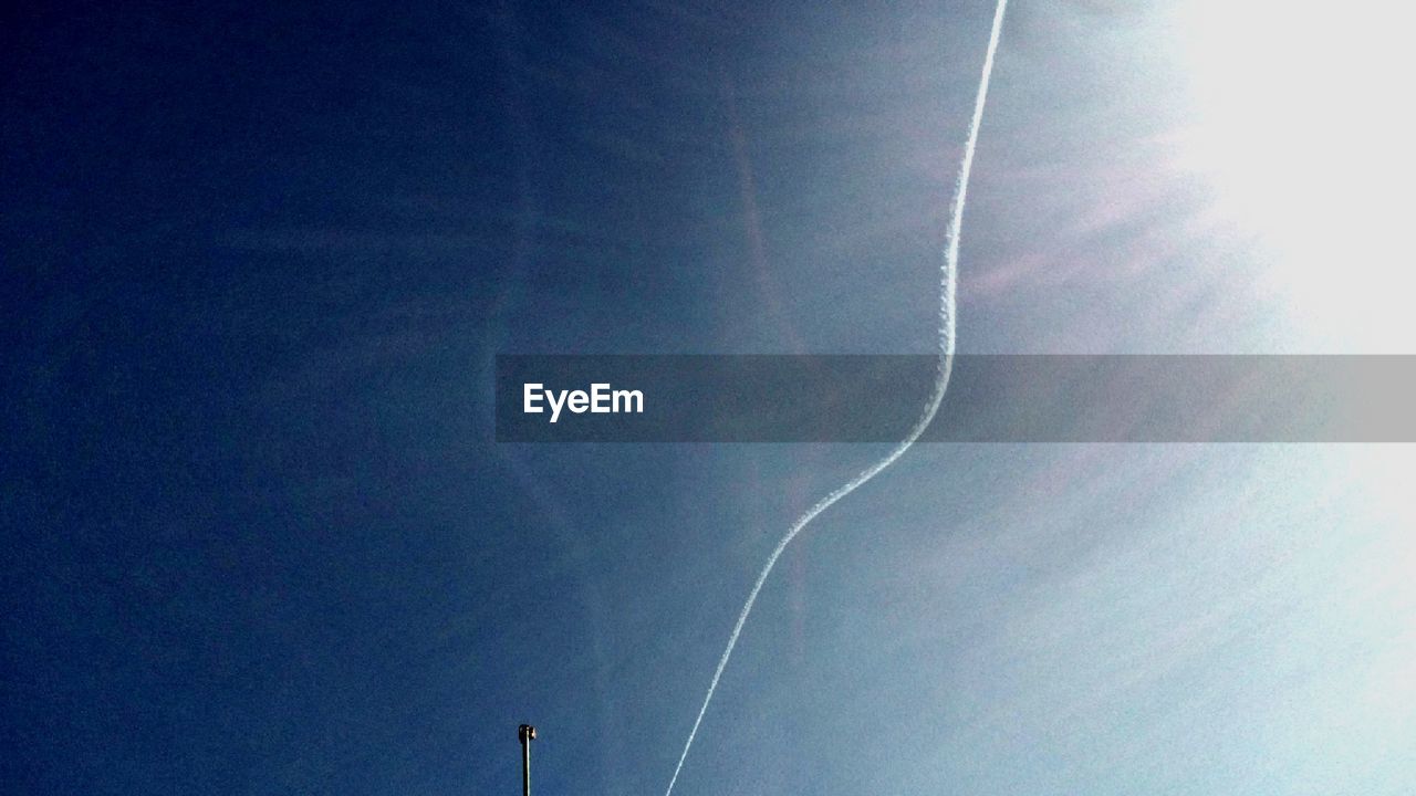 LOW ANGLE VIEW OF VAPOR TRAILS IN SKY