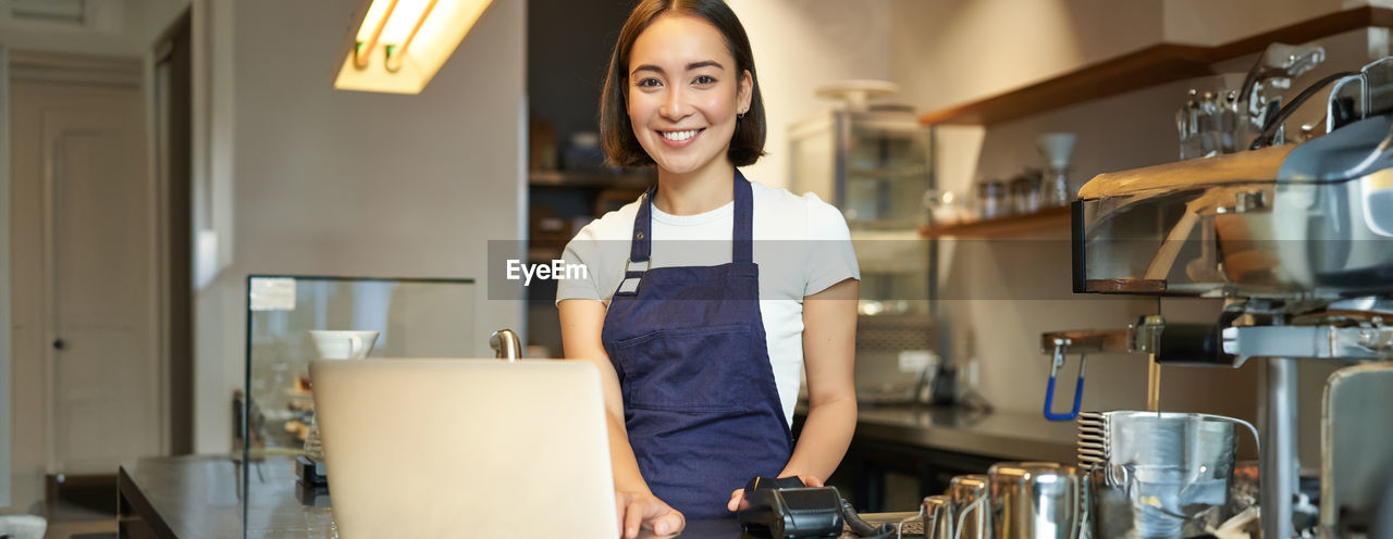 portrait of young woman standing in creative office