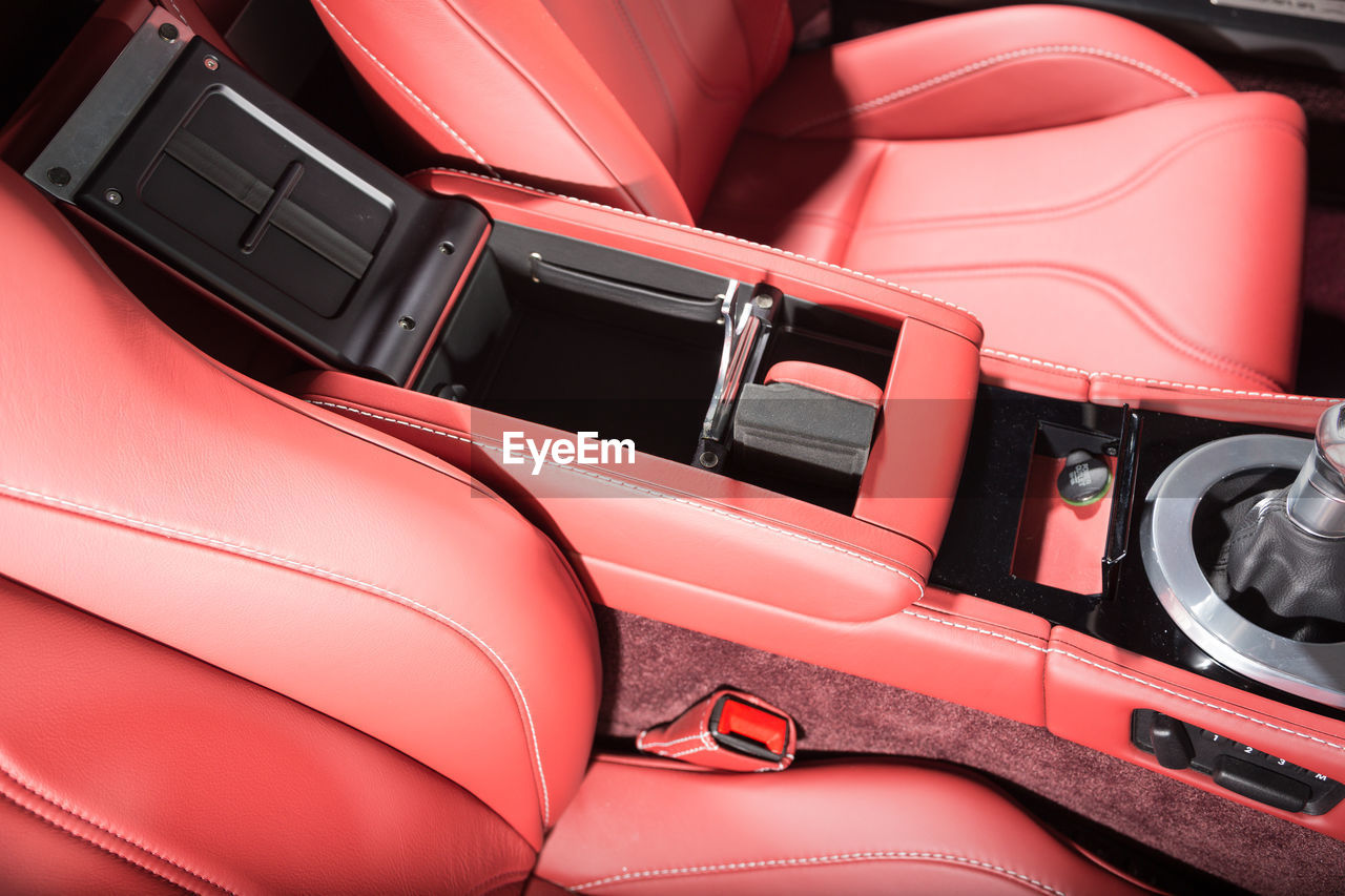 HIGH ANGLE VIEW OF RED VINTAGE CAR IN BUS