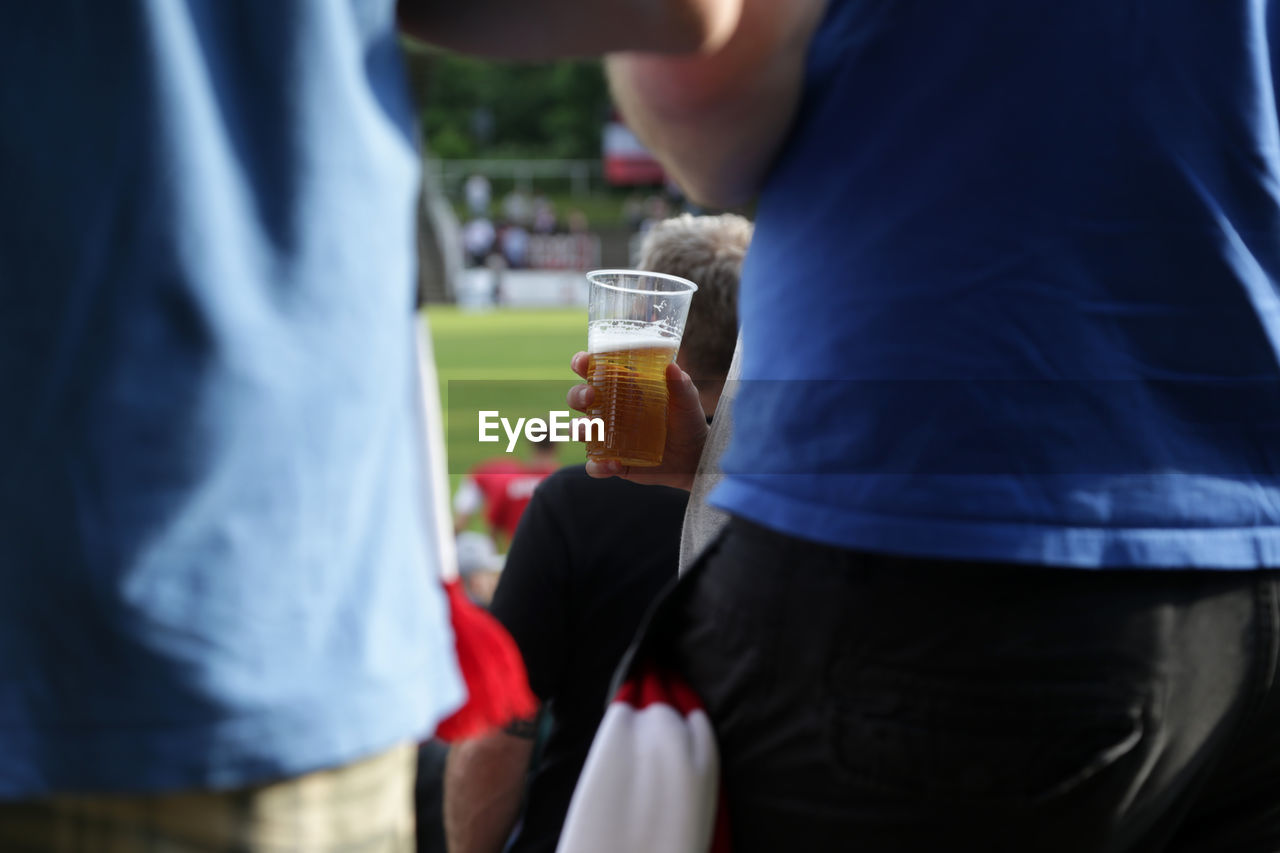 Cropped hand of person holding beer