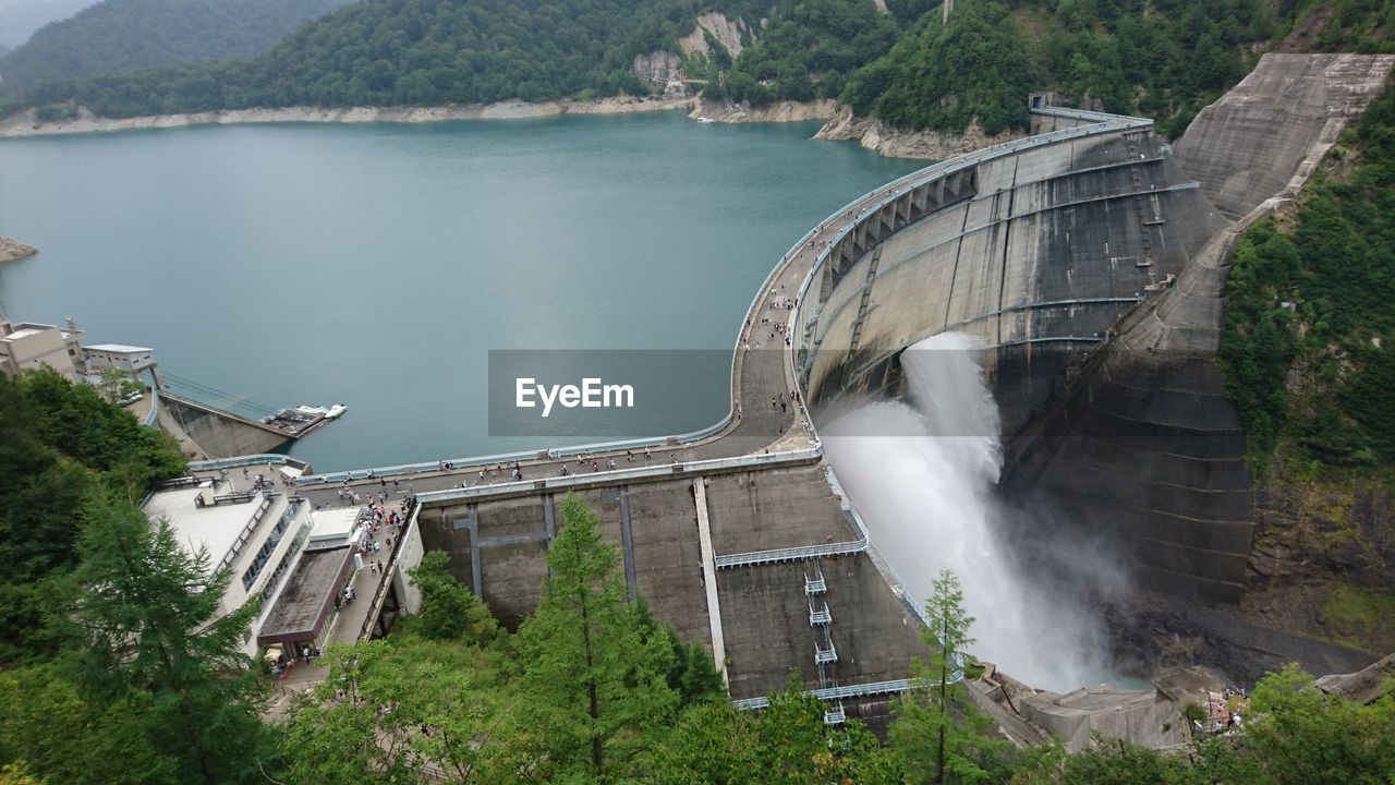 HIGH ANGLE VIEW OF DAM AND TREES BY WATER