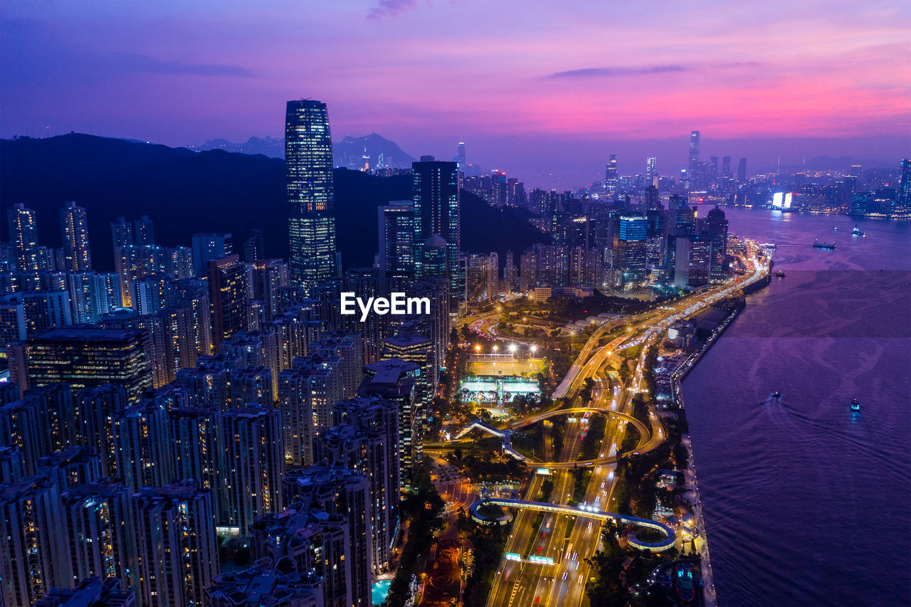 Aerial view of illuminated buildings in city at night