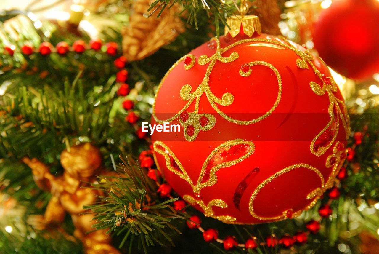 Close-up of red ornament on illuminated christmas tree